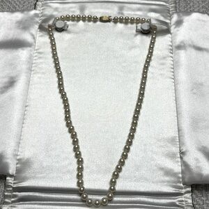 Strand of genuine pearls.